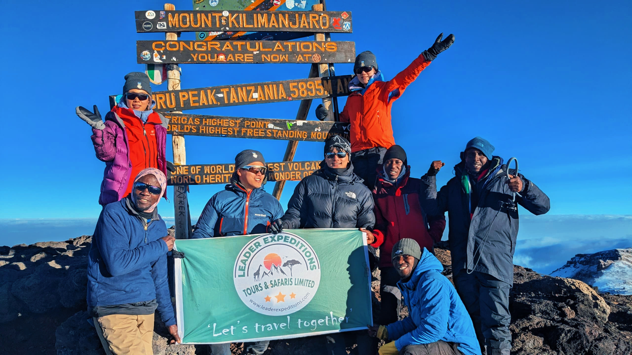 Hikers on top of Mount Kilimanjaro the top of Mount kilimanjaro